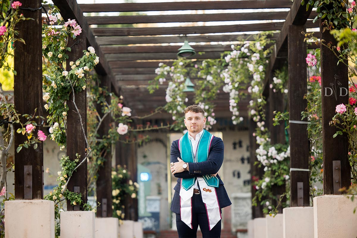 Graduation photo with flowered arches